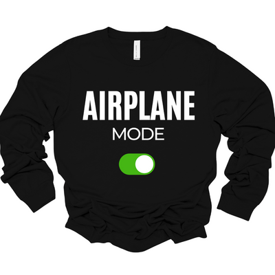 Black long sleeve unisex t-shirt with the bold words “AIRPLANE MODE” in white and a green toggle switch graphic.