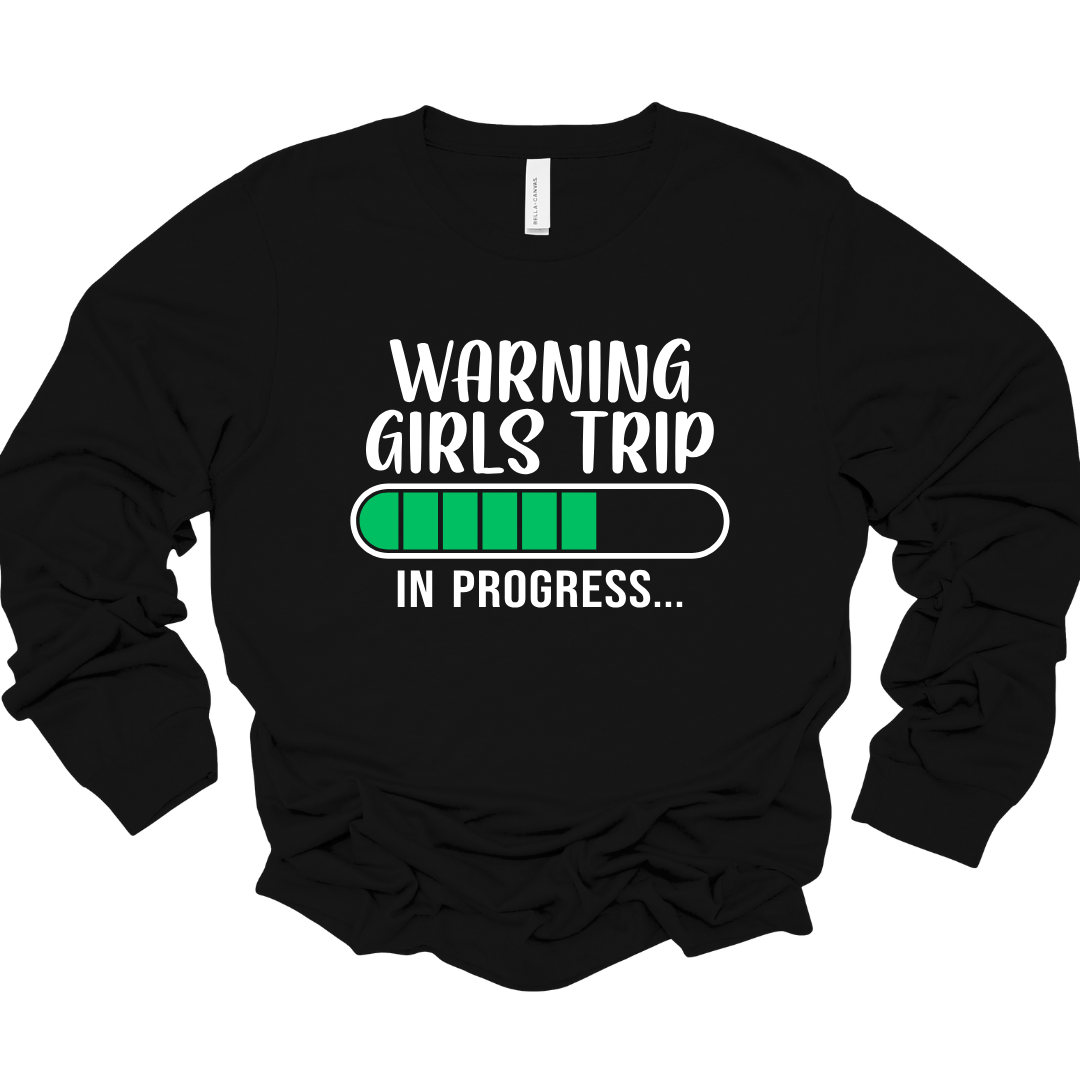 Black unisex long sleeve shirt with “Girls Trip In Progress” text and green progress bar graphic.