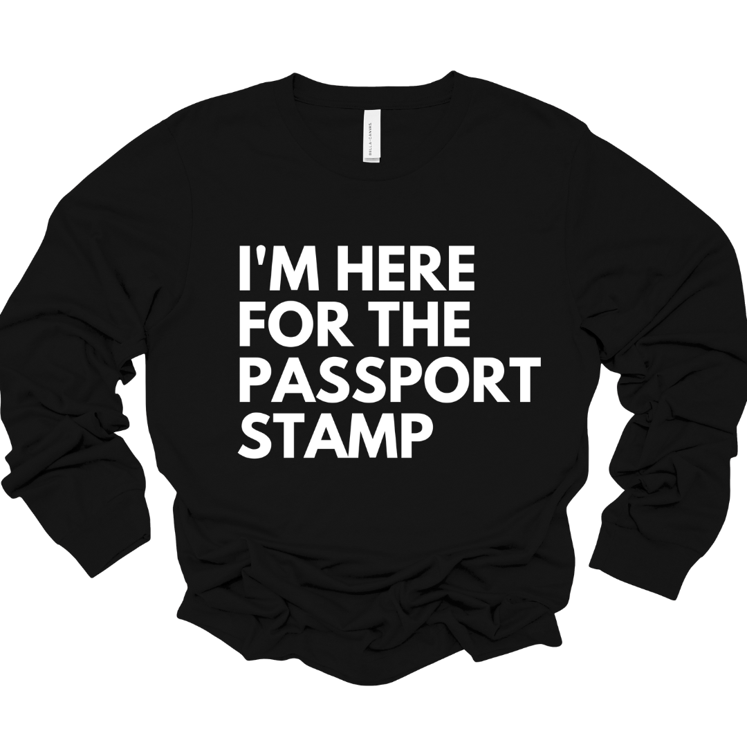 Black unisex long sleeve tee with bold white text reading "I'm Here for the Passport Stamp"