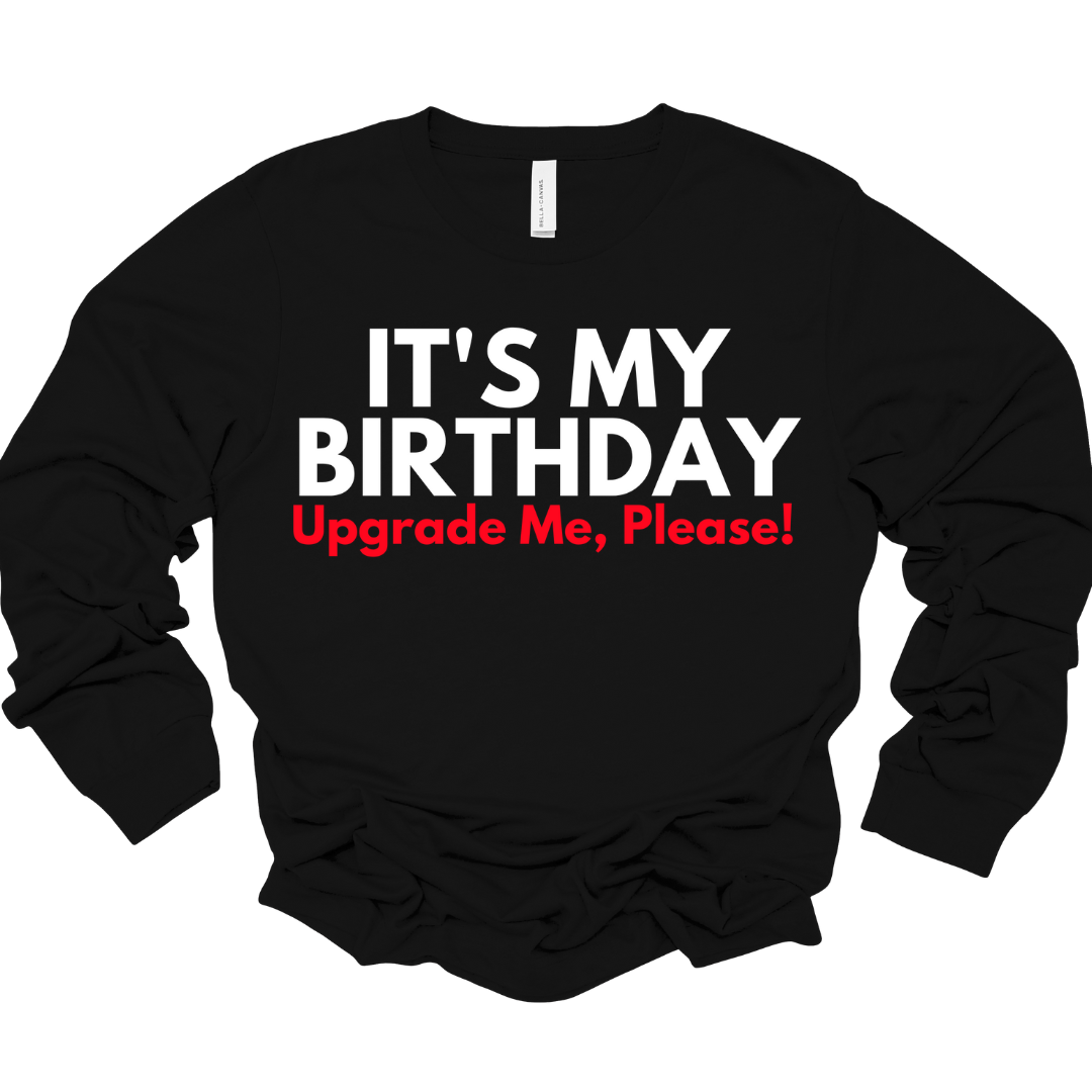 Black unisex long sleeve shirt with “Upgrade Me, Please” text in white and red.